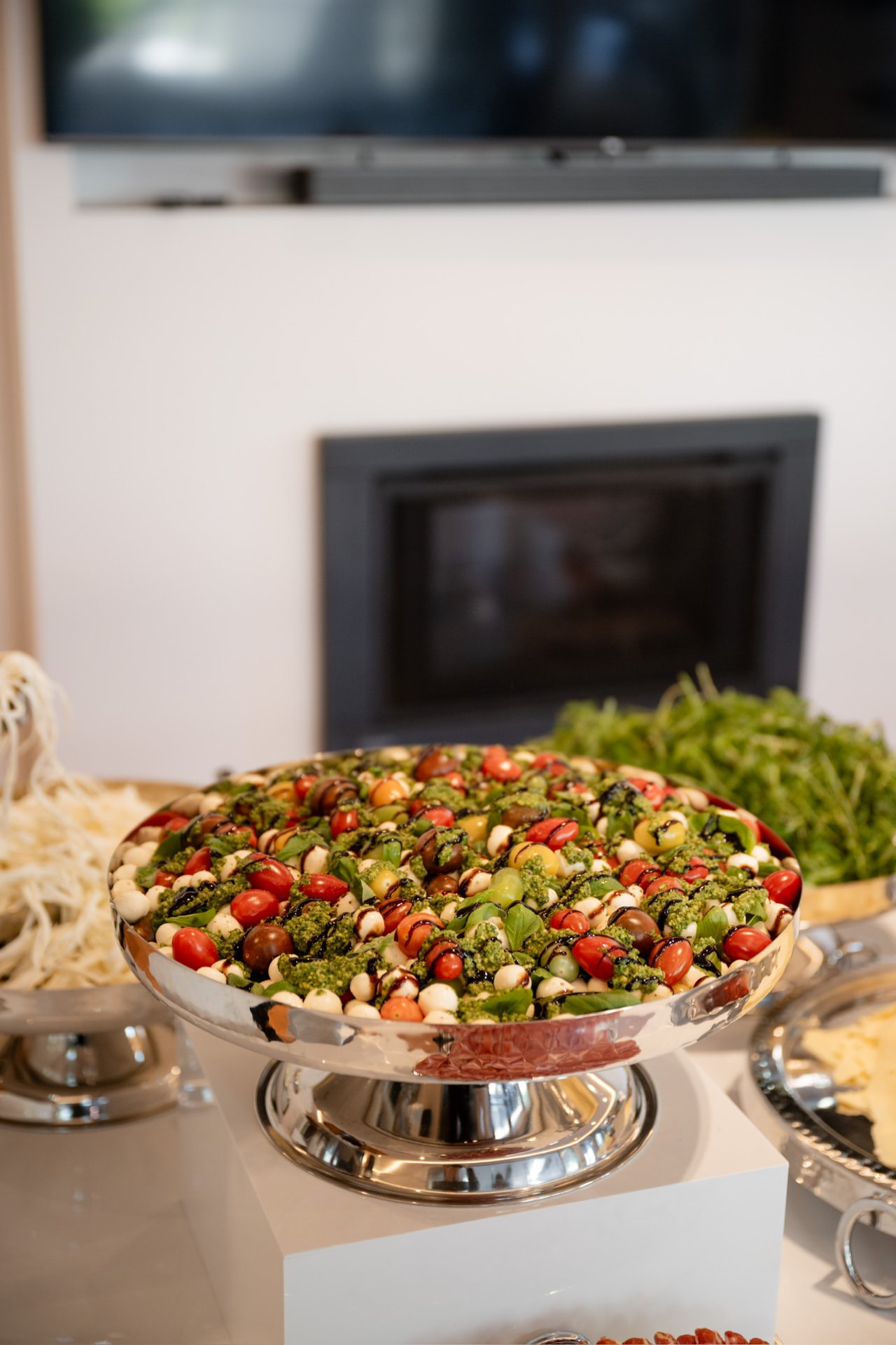 Caprese salad with basil and balsamic on a silver pedestal
