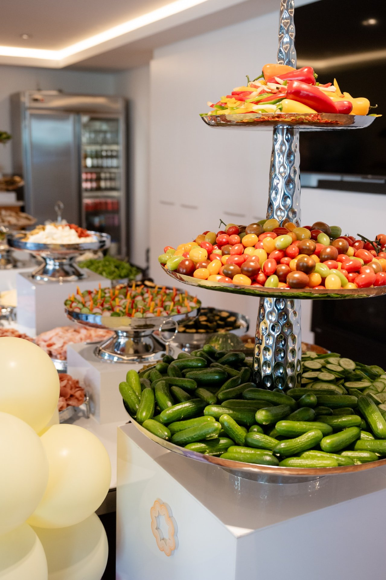 Hammered silver stand of cucumbers, tomatoes and peppers